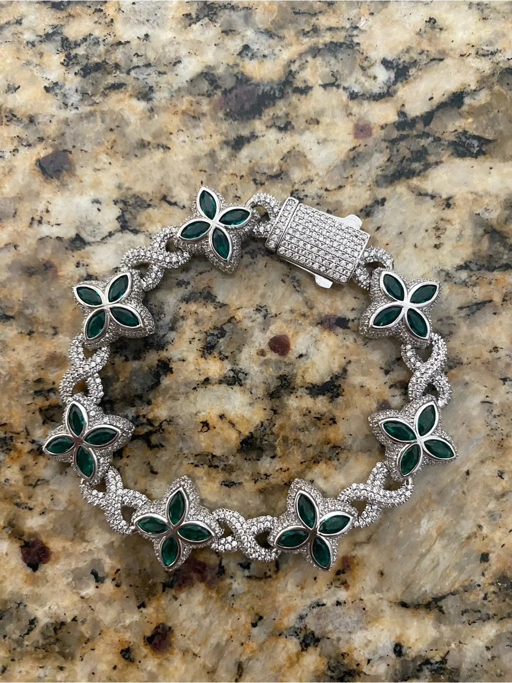 Sterling silver and moissanite floral bracelet with multi colored stones.